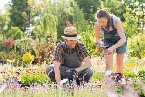 Gardener working in a lush garden in Millbank