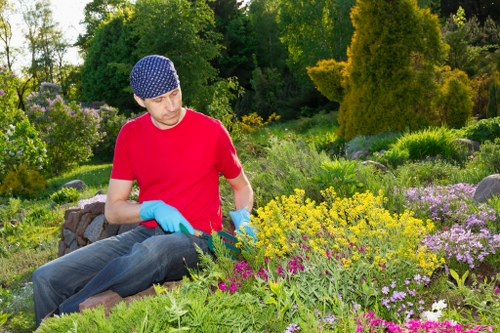 Expert landscaper working on a garden design in Kings Cross urban area.